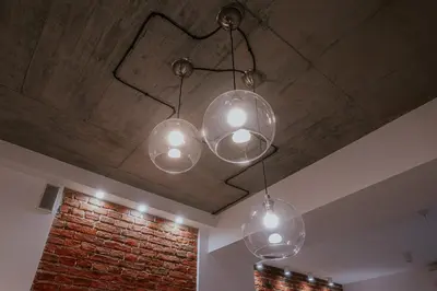 a group of three lights hanging from a ceiling at Old Town WAWEL Premium Apartment - 60m2 in Kraków