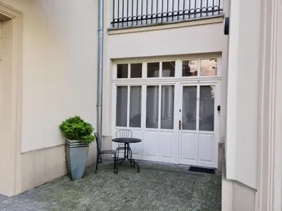 a patio with a table in front of a door at Old Town WAWEL Premium Apartment - 60m2 in Kraków