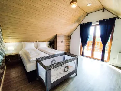 a bedroom with a large bed and a window at Wierchy Beskidu in Dobra