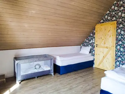 a small room with two beds and a door at Wierchy Beskidu in Dobra