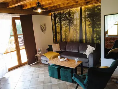 a living room with a couch and a table at Wierchy Beskidu in Dobra