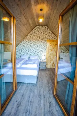 a bedroom with two beds and a large mirror at Wierchy Beskidu in Dobra