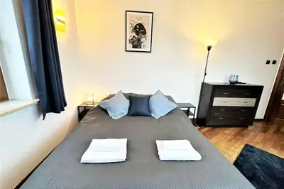 a bedroom with a bed with two towels on it at Exclusive PENTHOUSE near CityCenter 120m2 +NETFLIX in Kraków