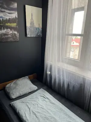 a bedroom with a bed and a window at Room in Old Town Krakow in Kraków