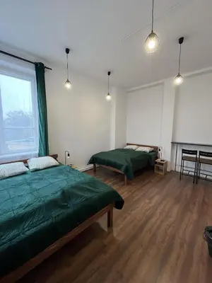 a room with two beds and a piano in it at Room in Old Town Krakow in Kraków