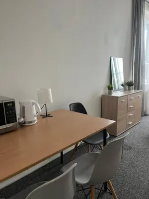 an office with a wooden table and chairs at Room in Old Town Krakow in Kraków