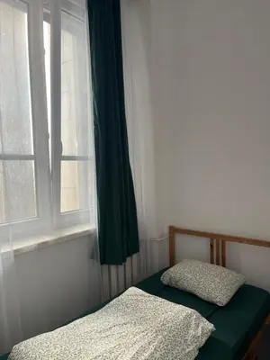 a bedroom with a bed and a window at Room in Old Town Krakow in Kraków