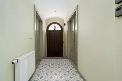a hallway with a door and a tile floor at Rose apartment in Kraków