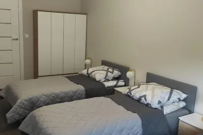 two beds in a room with two beds sidx sidx sidx at Nowoczesny apartament w pobliżu centrum in Kraków
