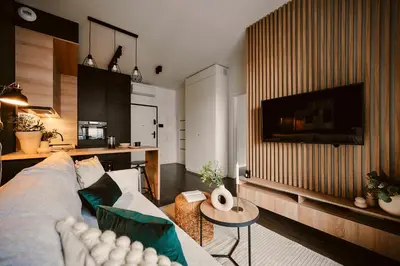 a living room with a couch and a table at Przytulny Apartament Greenwall in Kraków