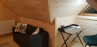 a small room with a couch and a table at beskid house in Spytkowice