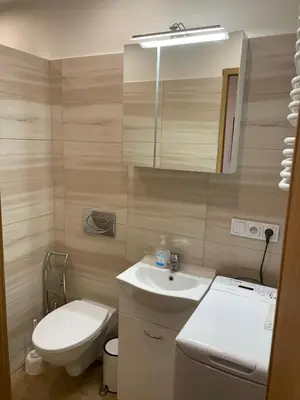 a bathroom with a sink and a toilet and a mirror at U Pająka in Wieprzec