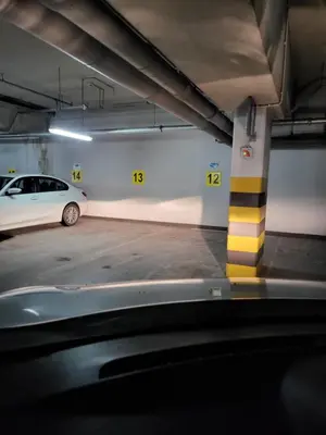 a parking garage with a car parked in it at AMBER APARTAMENt 519 in Kraków