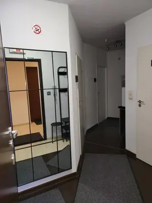 an empty hallway with a door and a mirror at AMBER APARTAMENt 519 in Kraków
