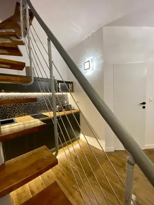 a staircase in a building with a metal railing at Apartament z jacuzzi in Kraków