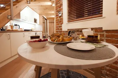 a kitchen with a table with a bowl of food on it at Wawel Corner Apartment in Kraków
