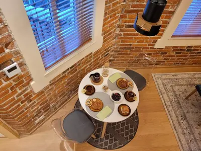 a table with donuts on it in a room at Wawel Corner Apartment in Kraków