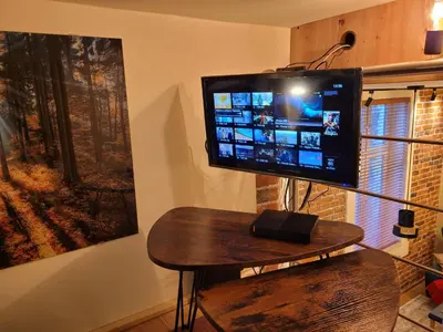 a television sitting on a table in a room at Wawel Corner Apartment in Kraków