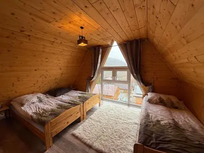 a jacuzzi tub in a room with a plant at Wzgórze w Cieniu Lasu in Łukowica