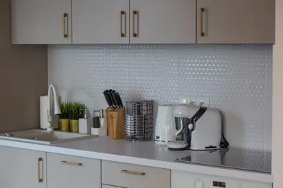 a kitchen with white cabinets and a counter top at Apartament in Bochnia