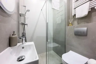 a bathroom with a shower and a sink and a toilet at Unique Style Apartments Old Town - 25 min from the airport - by Homelike Krakow in Kraków