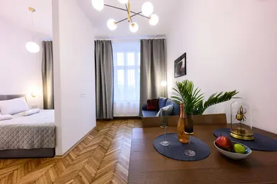 a living room with a bed and a table with fruit on it at Unique Style Apartments Old Town - 25 min from the airport - by Homelike Krakow in Kraków