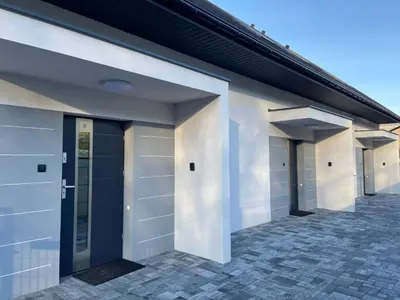 a row of garage doors on a house at 3 JASKÓŁKI in Kasina Wielka