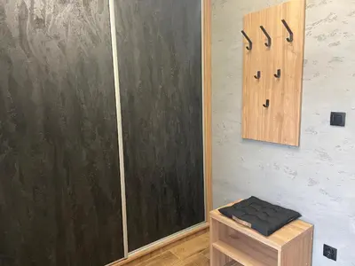 a room with a black door and a wooden stool at 3 JASKÓŁKI in Kasina Wielka