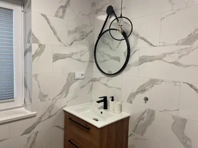 a bathroom with a sink and a mirror at 3 JASKÓŁKI in Kasina Wielka