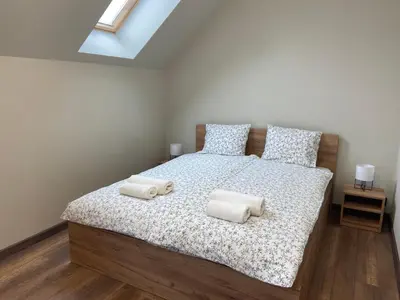 a bedroom with a bed with two pillows on it at 3 JASKÓŁKI in Kasina Wielka