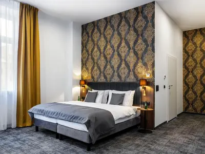 a bedroom with a king sized bed and a wall at Old Market Residence in Kraków