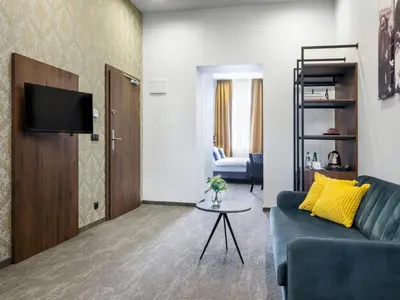 a living room with a couch and a table at Old Market Residence in Kraków
