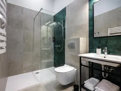 a bathroom with a shower and a toilet and a sink at Old Market Residence in Kraków