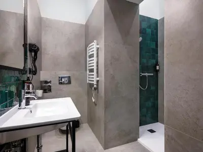 a bathroom with a sink and a shower at Old Market Residence in Kraków