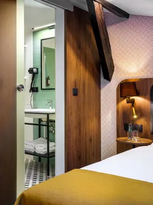 a bedroom with a bed and a sink and a mirror at Old Market Residence in Kraków