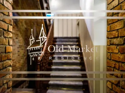 a sign for old market recessed in a brick wall at Old Market Residence in Kraków