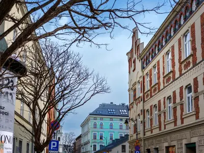 a city street with tall buildings and a blue sky at Old Market Residence in Kraków
