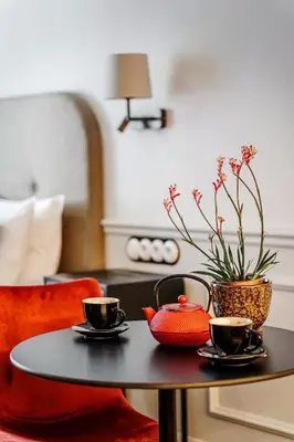 a coffee table with two cups and a vase on it at N33 Premium Apartments Old Town Kraków - Destigo Hotels in Kraków