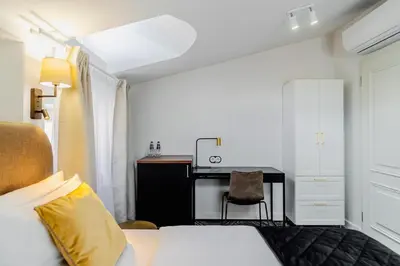a hotel room with a bed and a desk at N33 Premium Apartments Old Town Kraków - Destigo Hotels in Kraków