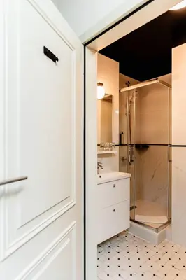 a bathroom with a shower and a glass door at N33 Premium Apartments Old Town Kraków - Destigo Hotels in Kraków