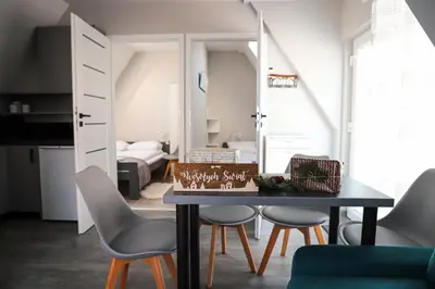 a dining room with a table and chairs and a bedroom at Agroturystyka Yvonne in Zawoja