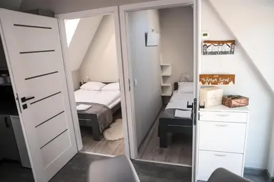a bedroom with a door leading to a bed at Agroturystyka Yvonne in Zawoja