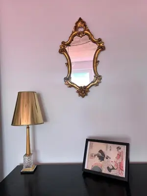 a lamp and a picture on a table with a mirror at Designer Loft 60m sq in Cracow Center Sunny Top-Floor Apartment with Balcony, King Bed & Great Transport in Kraków