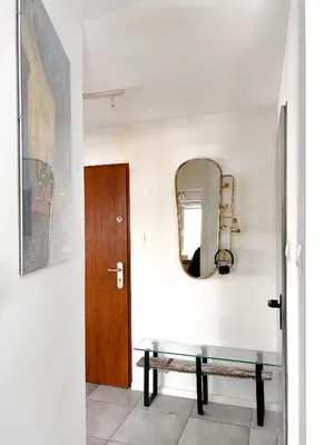 a hallway with a bench and a mirror at Designer Loft 60m sq in Cracow Center Sunny Top-Floor Apartment with Balcony, King Bed & Great Transport in Kraków