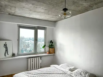 a bedroom with a bed and a window at Designer Loft 60m sq in Cracow Center Sunny Top-Floor Apartment with Balcony, King Bed & Great Transport in Kraków