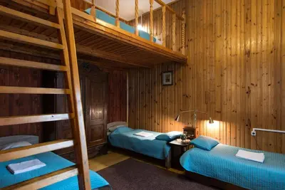 two bunk beds in a room with wooden walls at Big Cosy RETRO Apt, FREE PARKING, 15min OldTown & Kazimierz - by Homelike Krakow in Kraków