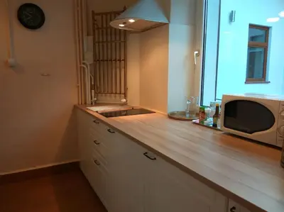 a kitchen with a counter with a microwave and a sink at Big Cosy RETRO Apt, FREE PARKING, 15min OldTown & Kazimierz - by Homelike Krakow in Kraków
