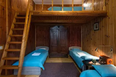 two bunk beds in a room with a ladder at Big Cosy RETRO Apt, FREE PARKING, 15min OldTown & Kazimierz - by Homelike Krakow in Kraków