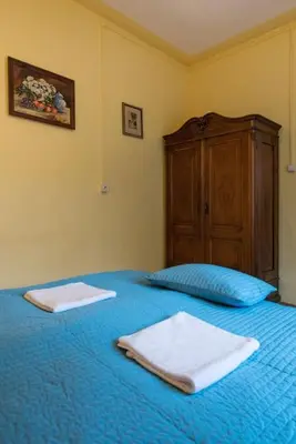a bedroom with a blue bed with two towels on it at Big Cosy RETRO Apt, FREE PARKING, 15min OldTown & Kazimierz - by Homelike Krakow in Kraków