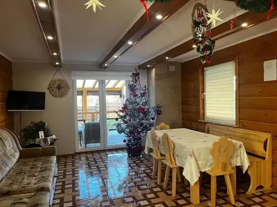 a room with a table and a christmas tree in it at Noclegi Gal in Odrowąż